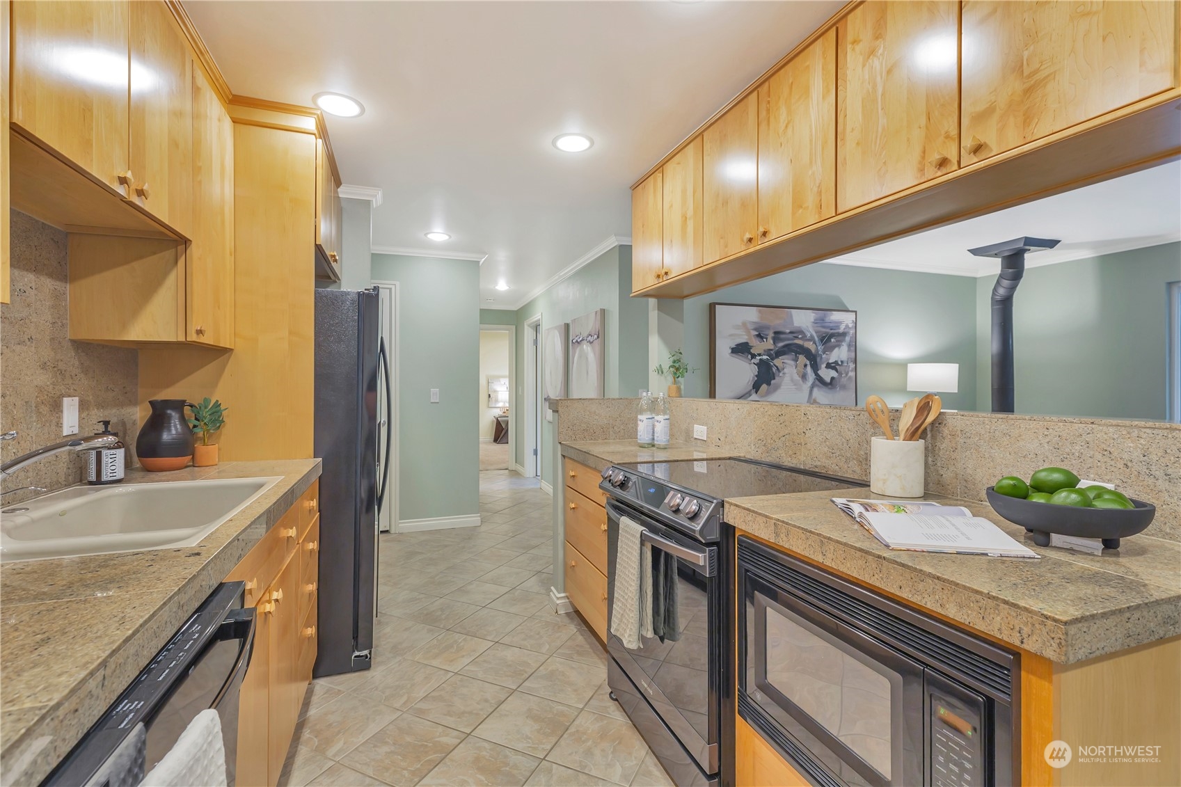 5021 Ripley Lane North, Unit 306 Renton, WA 98056 - Photo 7 of 22 a kitchen with stainless steel appliances granite countertop a sink and a stove