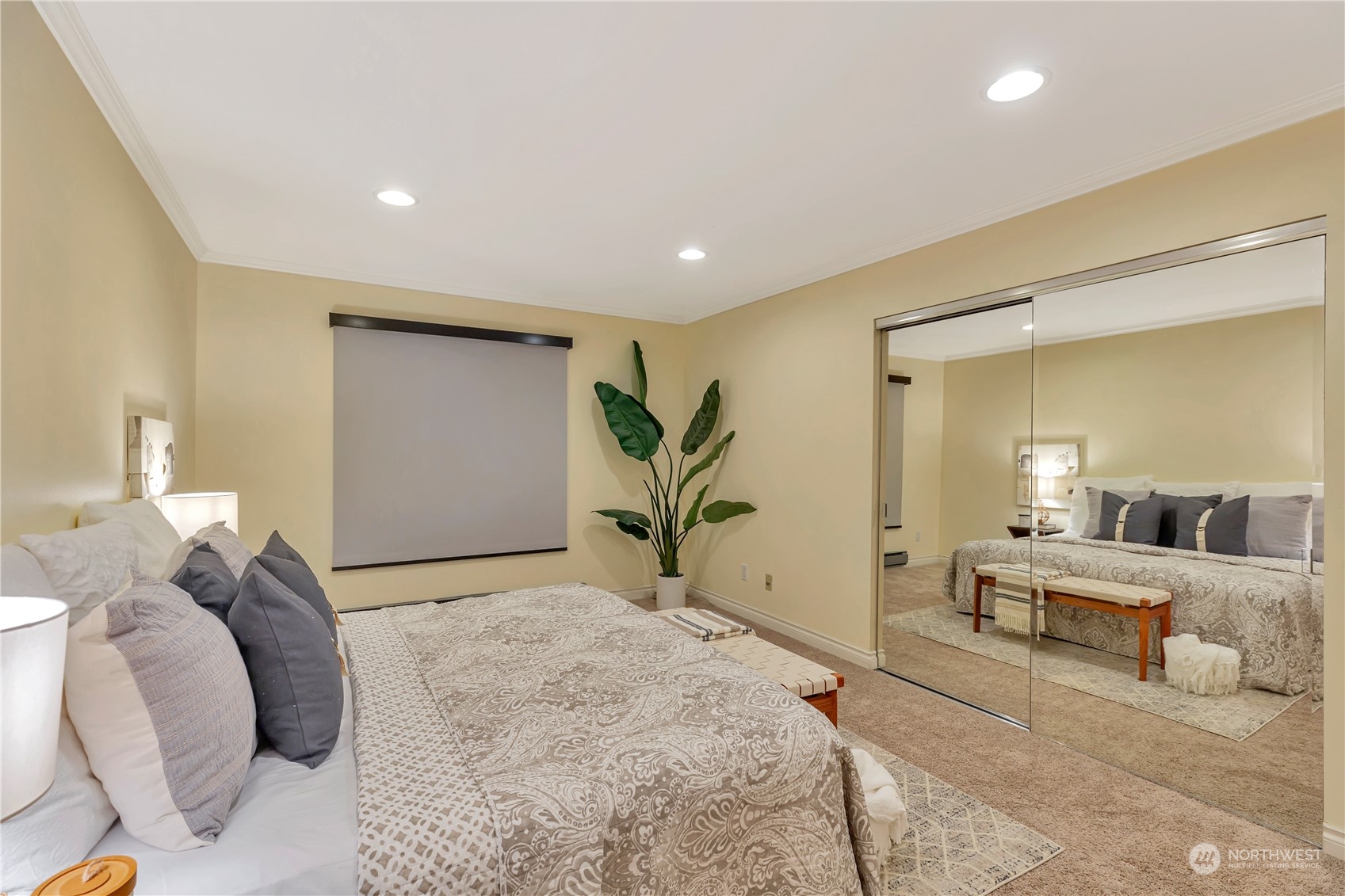 5021 Ripley Lane North, Unit 306 Renton, WA 98056 - Photo 9 of 22 a bedroom with a large bed and a chandelier