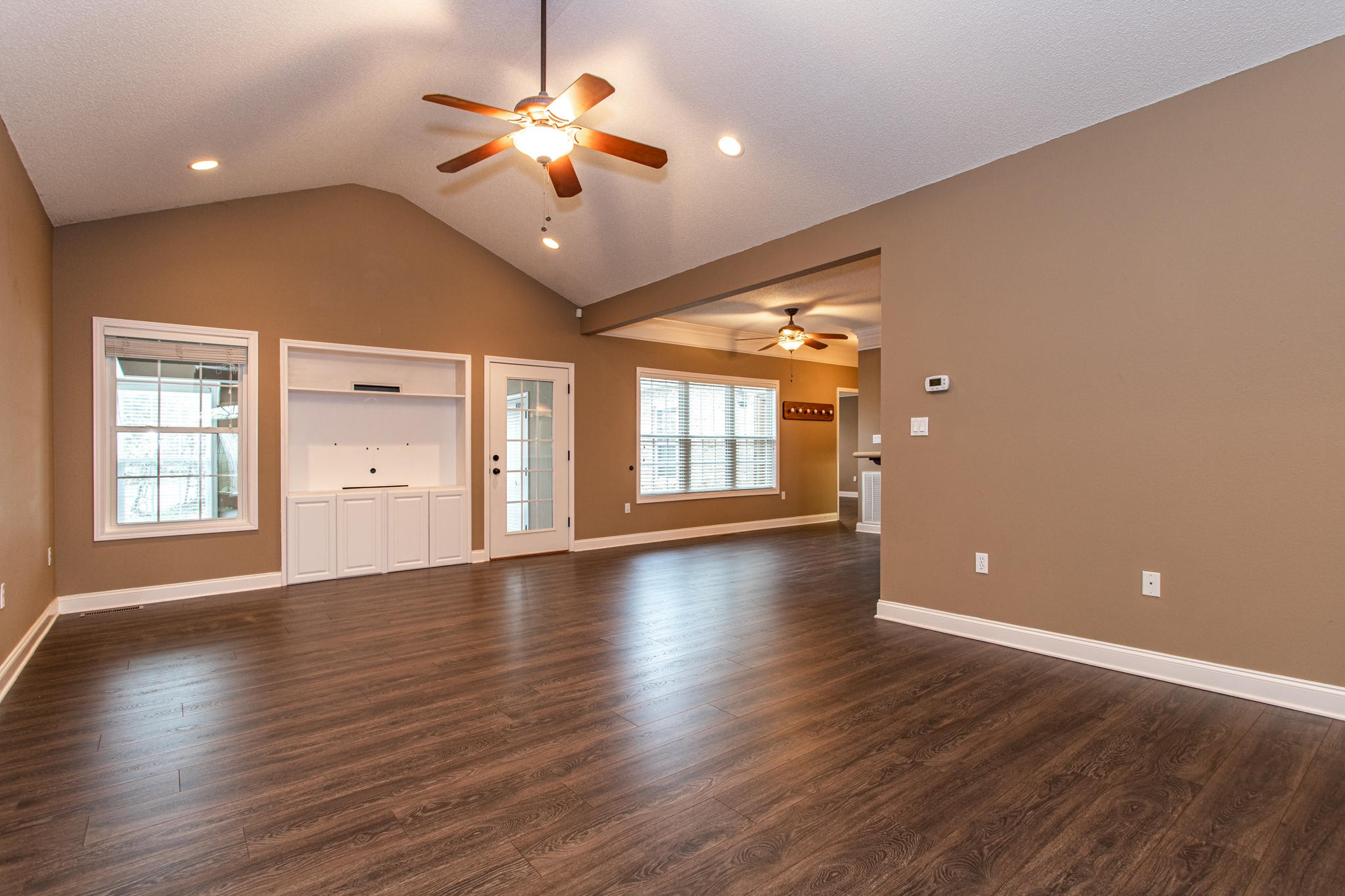 1044 Kodak Road Kodak, TN 37764 - Photo 8 of 39 a view of an empty room with a window and wooden floor