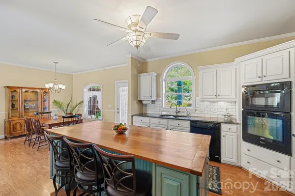 a kitchen with a table chairs and microwave
