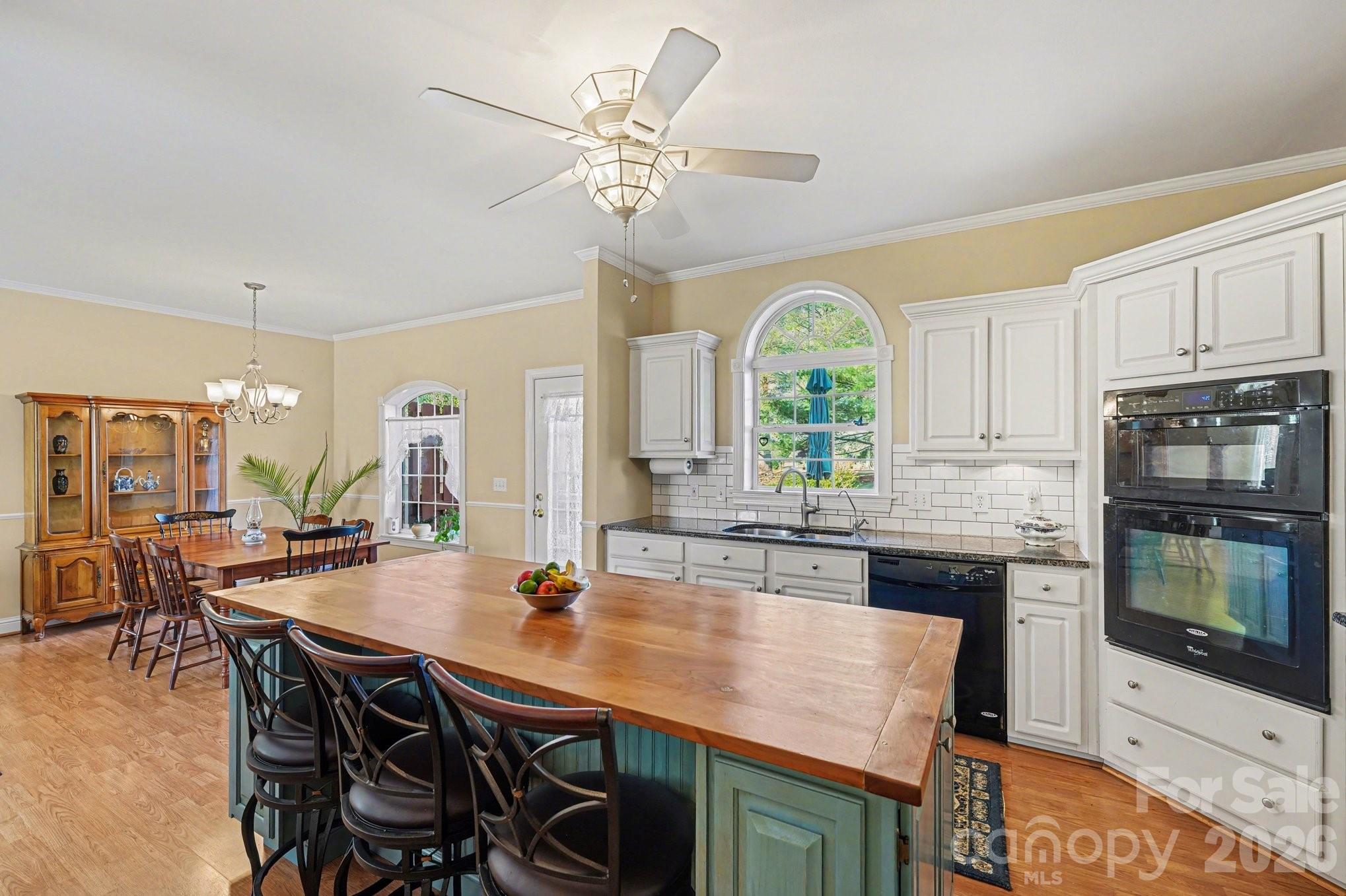 212 Pine Valley Road Mocksville, NC 27028 - Photo 11 of 28 a kitchen with a table chairs and microwave