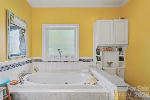 a white bath tub sitting next to a bathroom sink