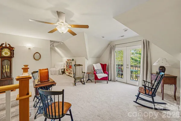 a living room with furniture a air conditioner and a window