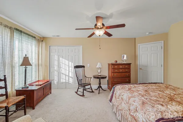 a bedroom with a bed a table and chair