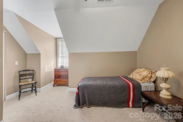 a bedroom with a bed and furniture