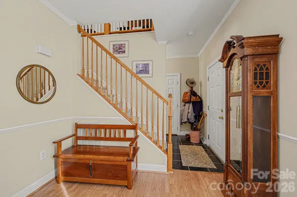 a view of entryway and hall with wooden floor
