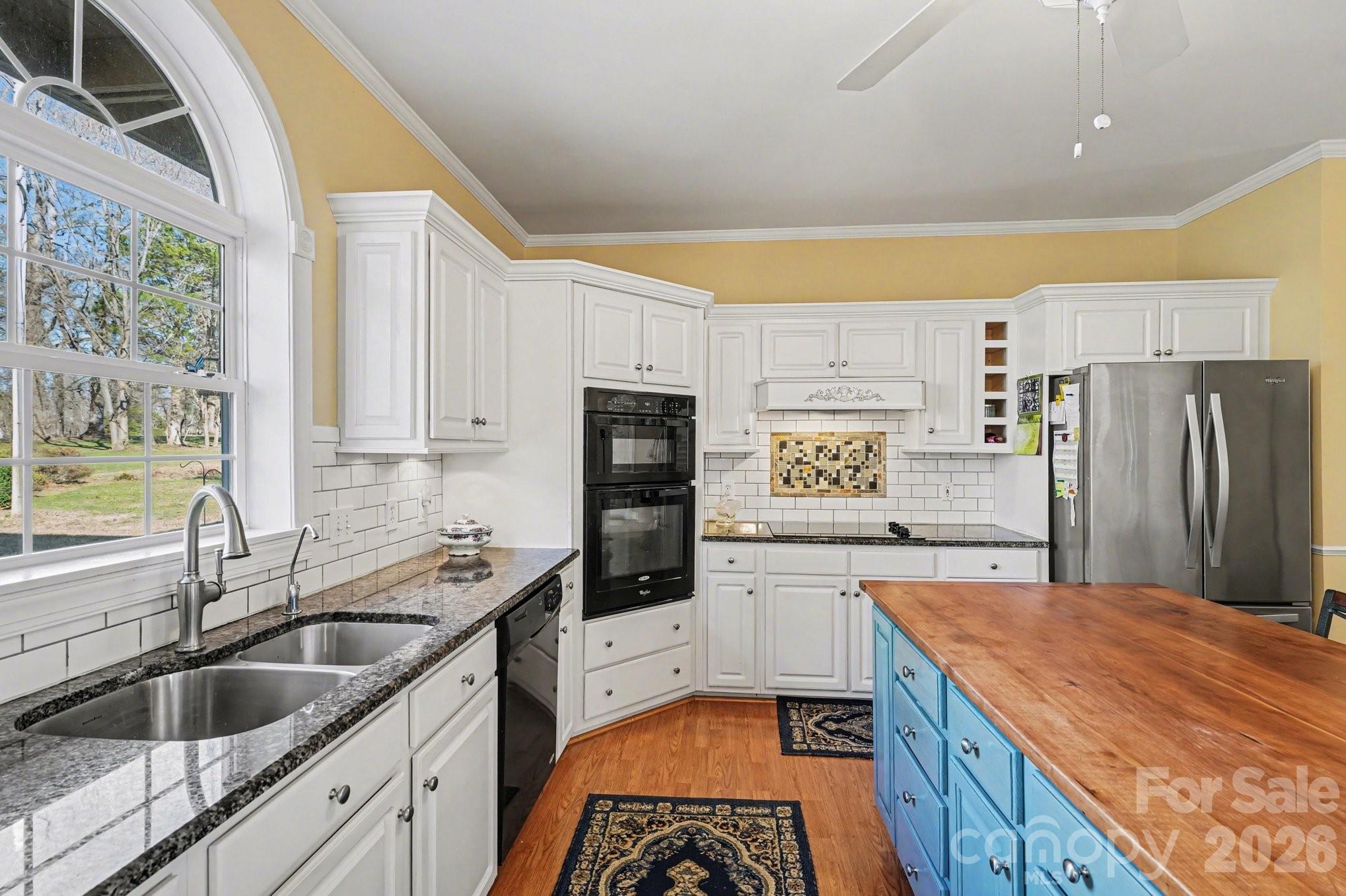 212 Pine Valley Road Mocksville, NC 27028 - Photo 10 of 28 a kitchen with granite countertop a sink stainless steel appliances a counter top space and cabinets