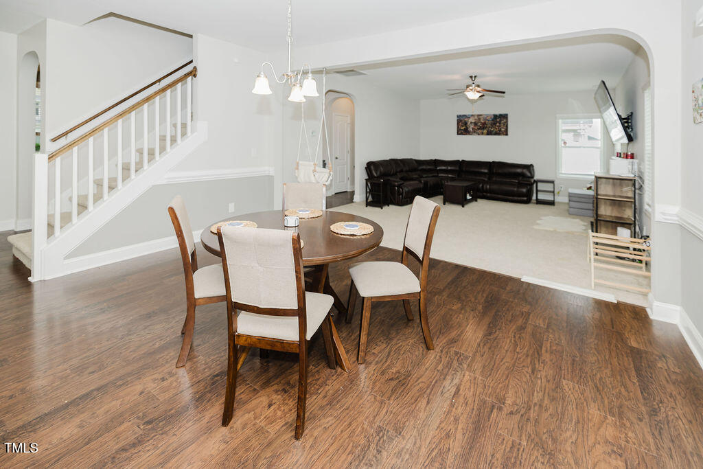 105 Perignon Drive Princeton, NC 27569 - Photo 12 of 38 a view of a dining room with furniture and wooden floor