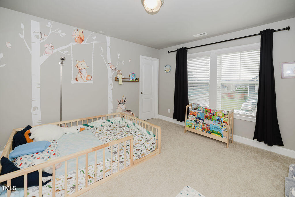 105 Perignon Drive Princeton, NC 27569 - Photo 14 of 38 a bedroom with a bed and a window