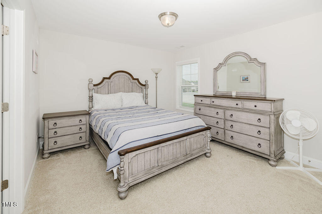 105 Perignon Drive Princeton, NC 27569 - Photo 15 of 38 a bedroom with a bed and a dresser