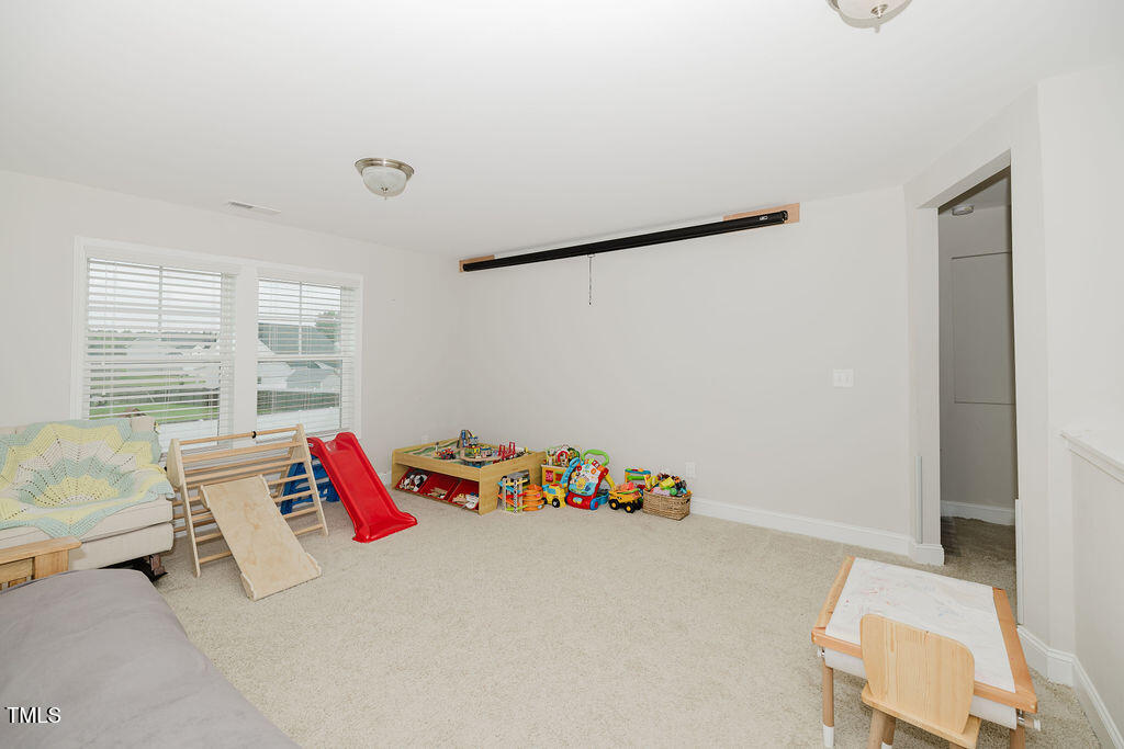 105 Perignon Drive Princeton, NC 27569 - Photo 18 of 38 a bed room with a bed and a couch