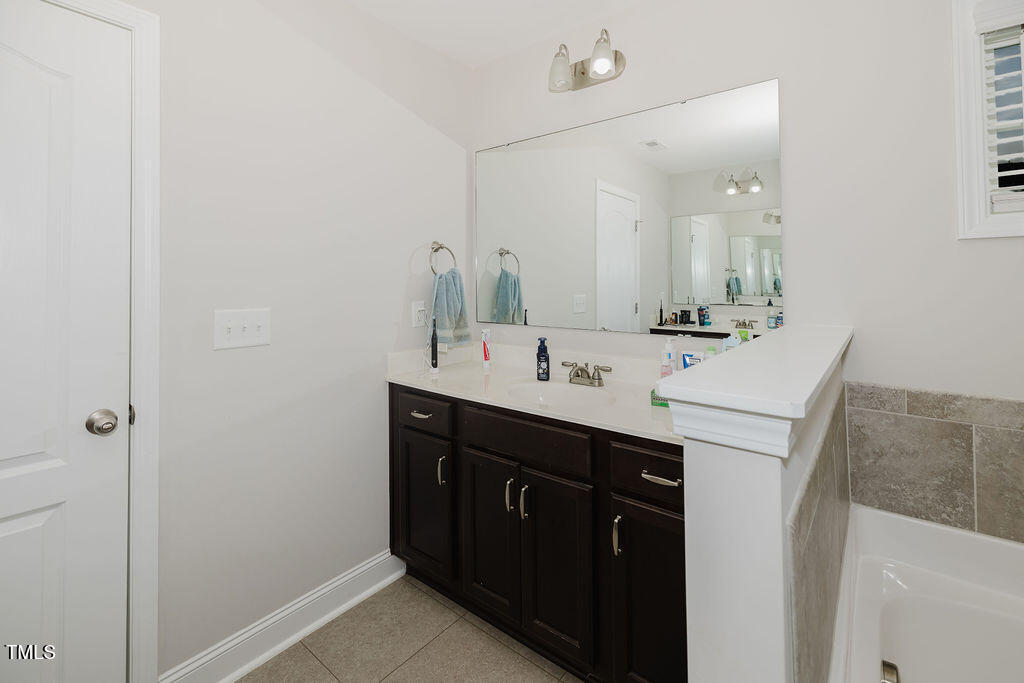 105 Perignon Drive Princeton, NC 27569 - Photo 23 of 38 a bathroom with a sink and a mirror