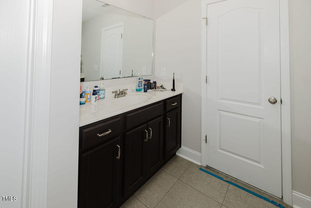 105 Perignon Drive Princeton, NC 27569 - Photo 24 of 38 a bathroom with a sink vanity and mirror