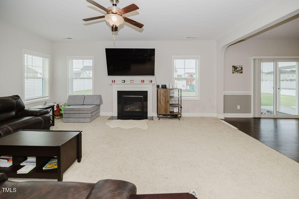105 Perignon Drive Princeton, NC 27569 - Photo 4 of 38 a living room with furniture a fireplace and a flat screen tv