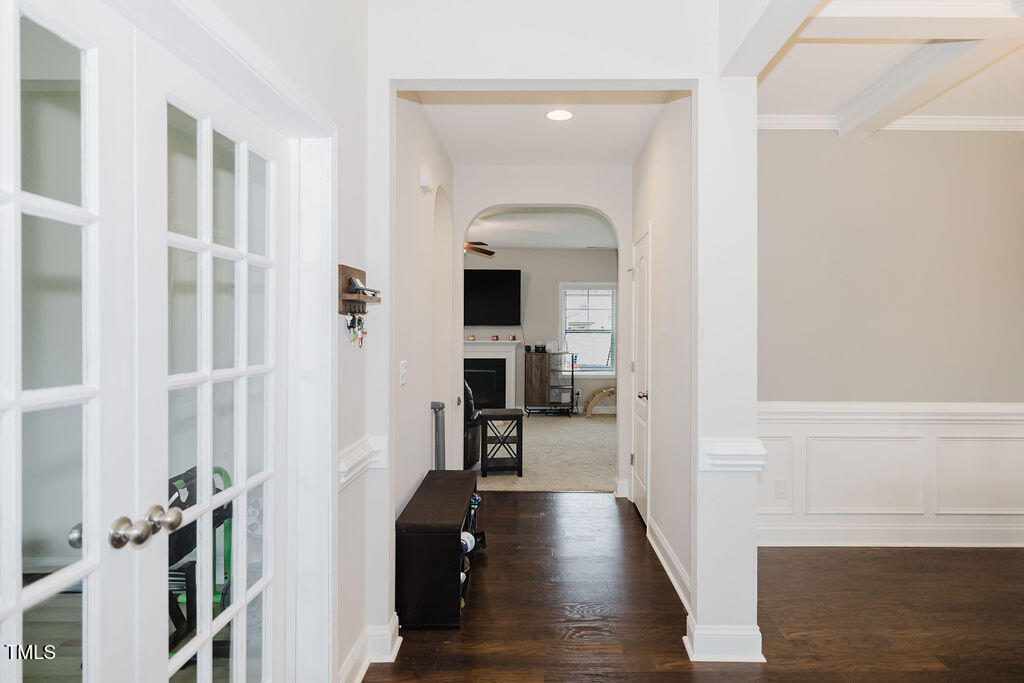 105 Perignon Drive Princeton, NC 27569 - Photo 6 of 38 a view of a hallway with wooden floor and a living room