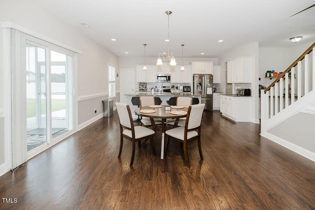 105 Perignon Drive Princeton, NC 27569 - Photo 8 of 38 a view of a dining room with furniture window and wooden floor