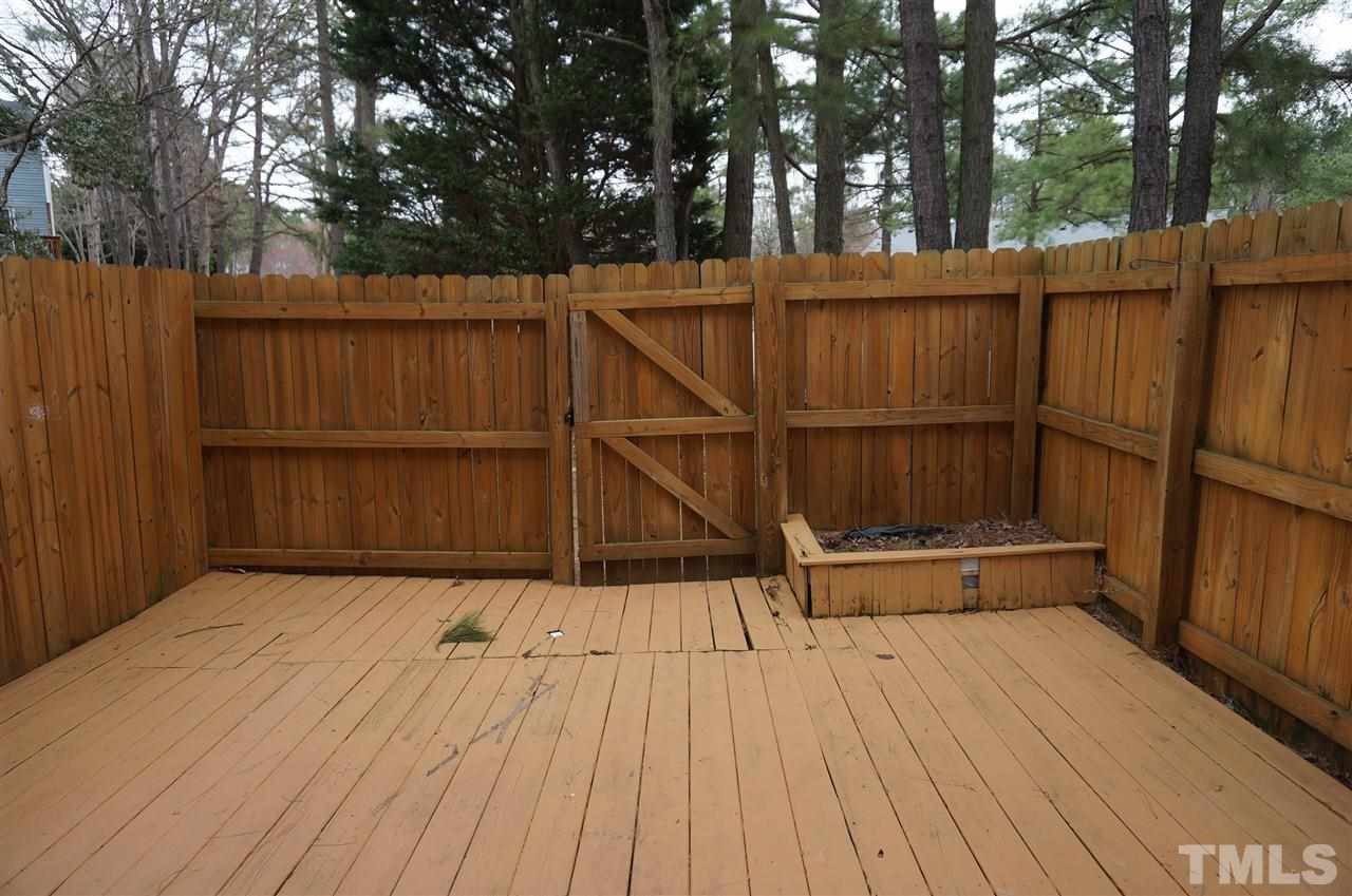 7700 Ohmann Court Raleigh, NC 27615 - Photo 17 of 20 a view of backyard with wooden floor and fence