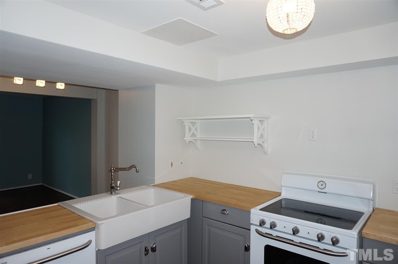7700 Ohmann Court Raleigh, NC 27615 - Photo 5 of 20 a room with a sink and a mirror