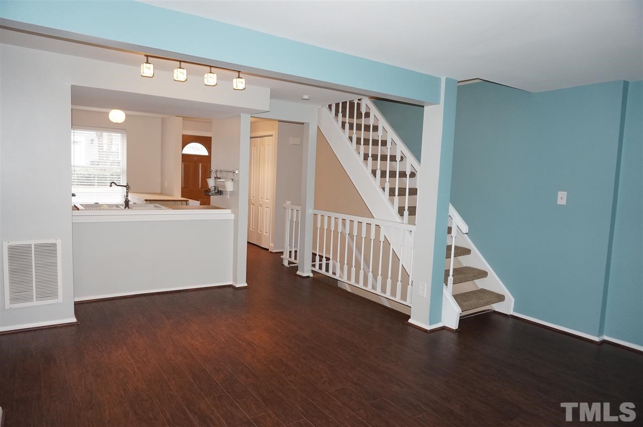 7700 Ohmann Court Raleigh, NC 27615 - Photo 8 of 20 a view of a hallway with wooden floor and staircase