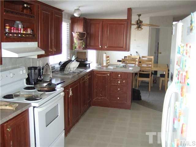 205 Cousin Road Rougemont, NC 27572 - Photo 3 of 8 a kitchen with a sink stove and cabinets