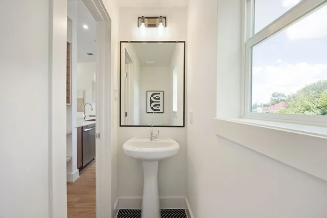 a bathroom with a sink mirror and shower