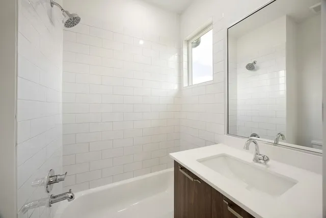a bathroom with a sink shower and a bathtub