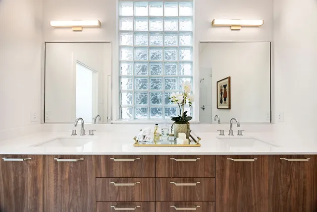 a bathroom with a double vanity sink and a mirror
