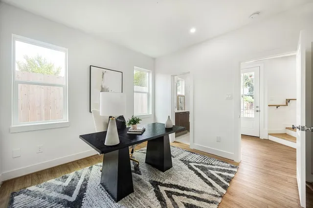 a living room with furniture and wooden floor