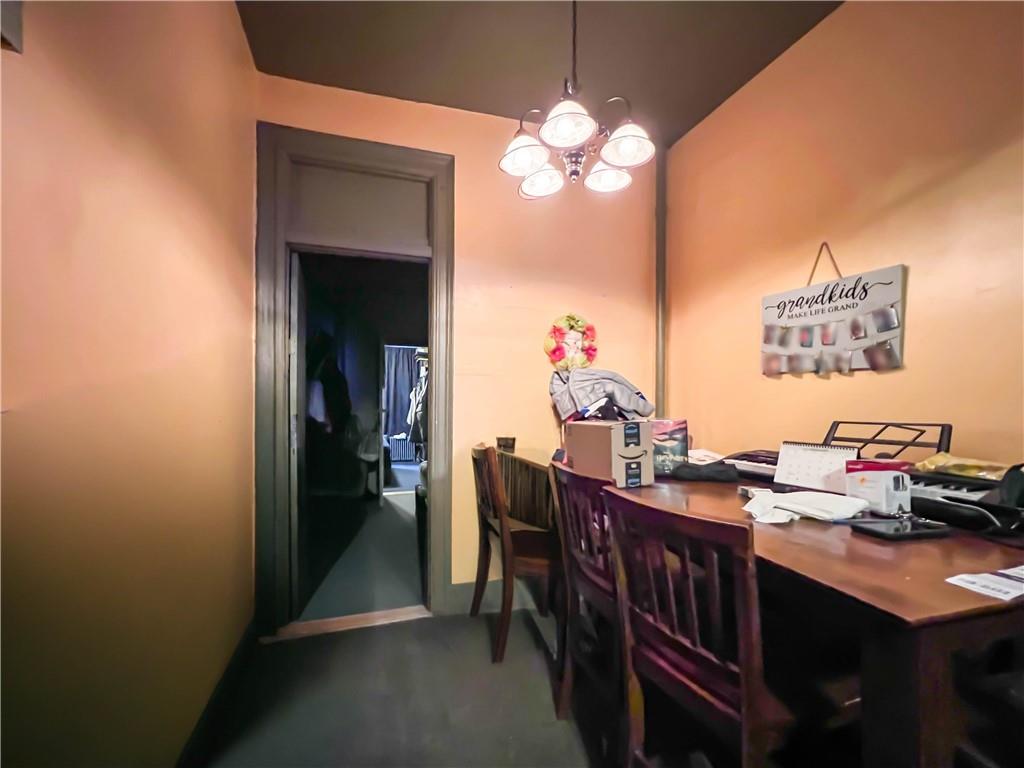 5907 4th Avenue Brooklyn, NY 11220 - Photo 14 of 37 a view of a dining room with furniture and chandelier