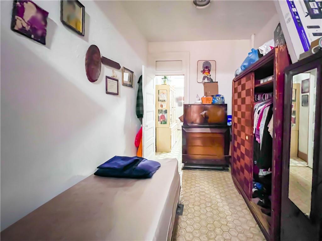 5907 4th Avenue Brooklyn, NY 11220 - Photo 16 of 37 a kitchen with a refrigerator and a stove
