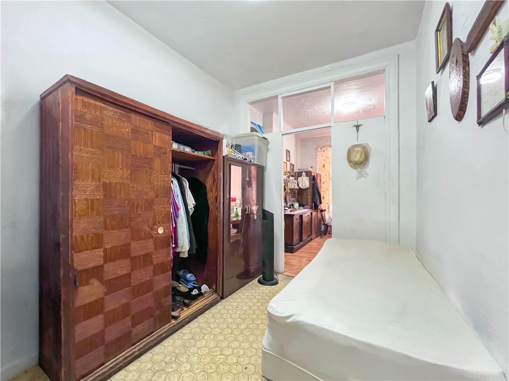 5907 4th Avenue Brooklyn, NY 11220 - Photo 17 of 37 a hallway with two black and white walls