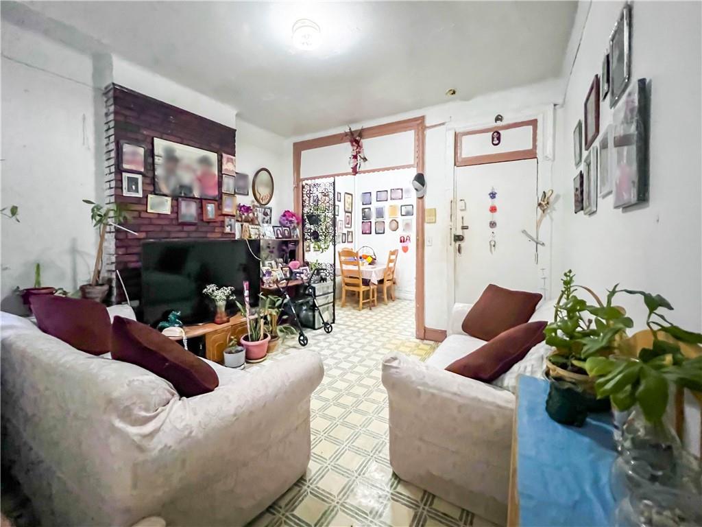 5907 4th Avenue Brooklyn, NY 11220 - Photo 20 of 37 a living room with furniture a fireplace and a flat screen tv