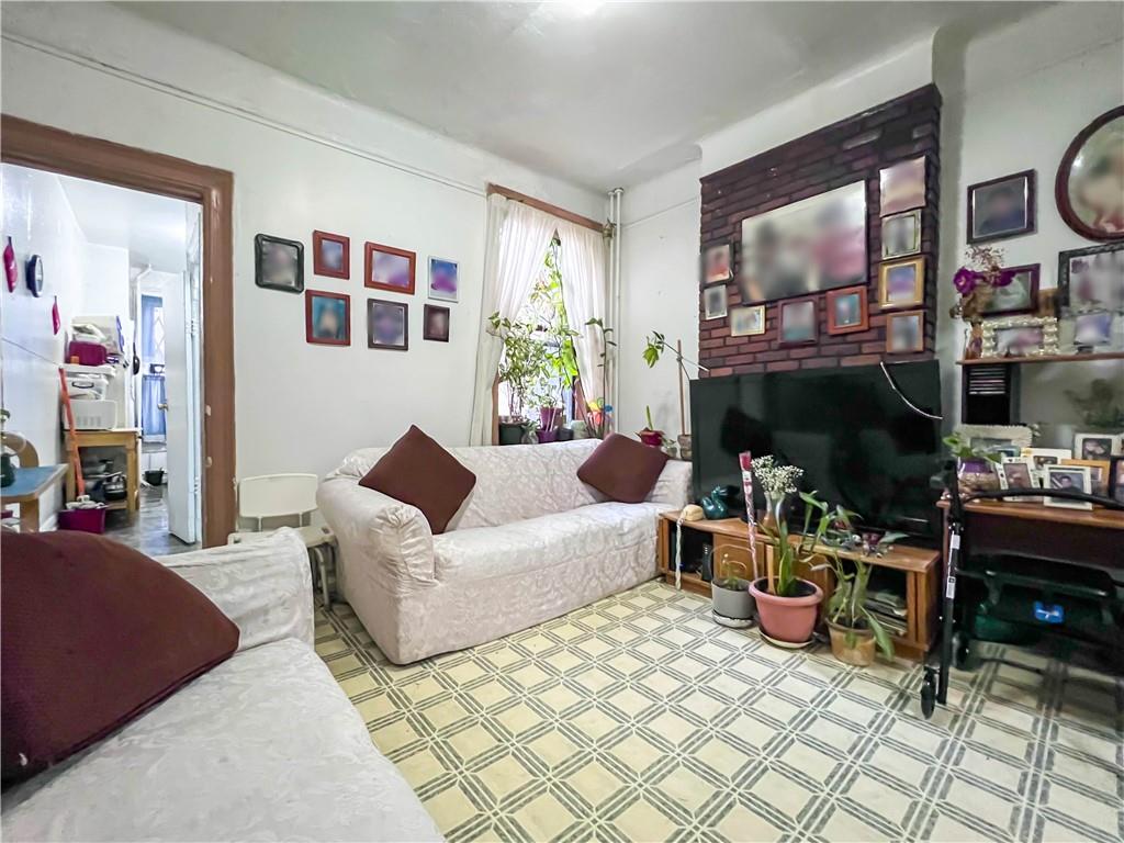 5907 4th Avenue Brooklyn, NY 11220 - Photo 21 of 37 a living room with furniture and a fireplace