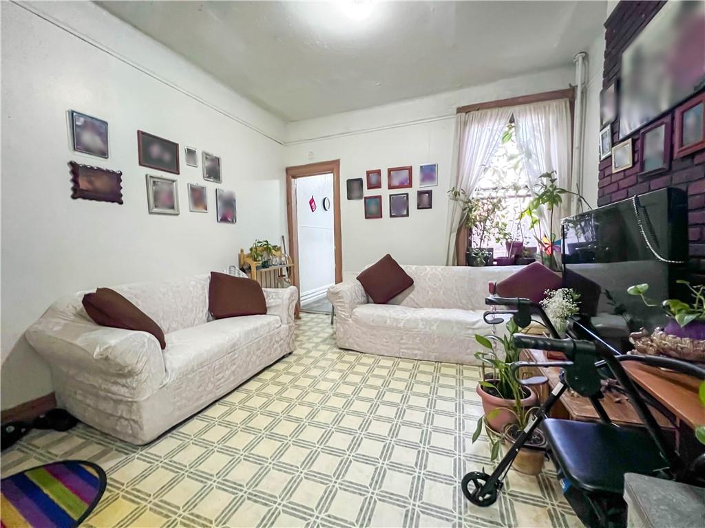 5907 4th Avenue Brooklyn, NY 11220 - Photo 22 of 37 a living room with furniture fireplace and flat screen tv