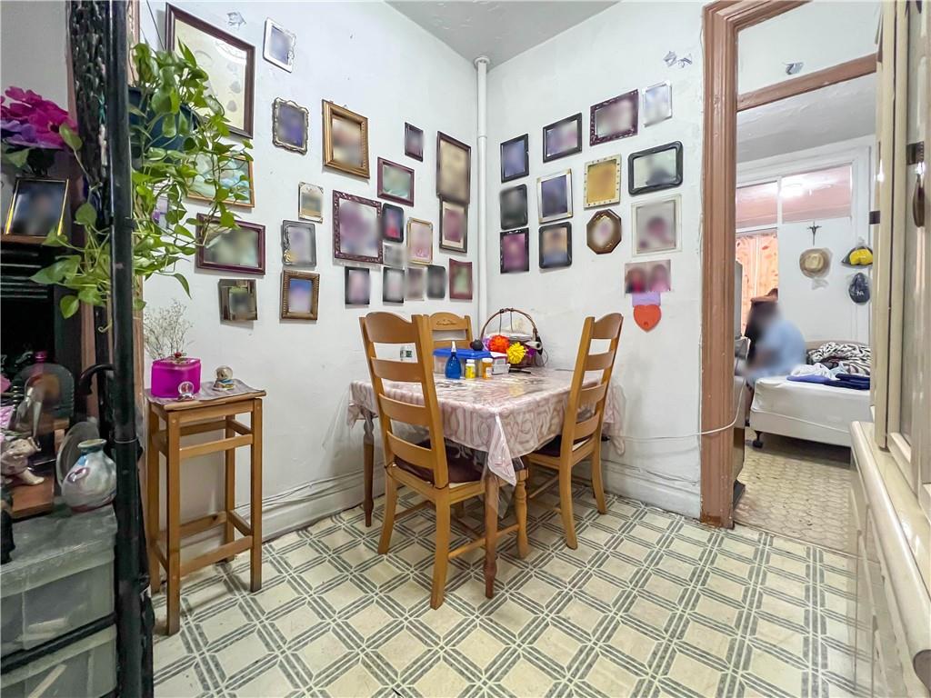 5907 4th Avenue Brooklyn, NY 11220 - Photo 23 of 37 a view of a dining room with furniture and chandelier