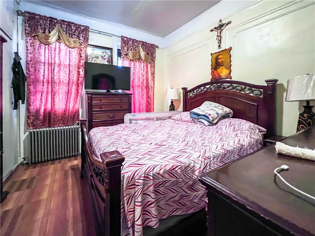 5907 4th Avenue Brooklyn, NY 11220 - Photo 33 of 37 a bedroom with a bed and a flat screen tv