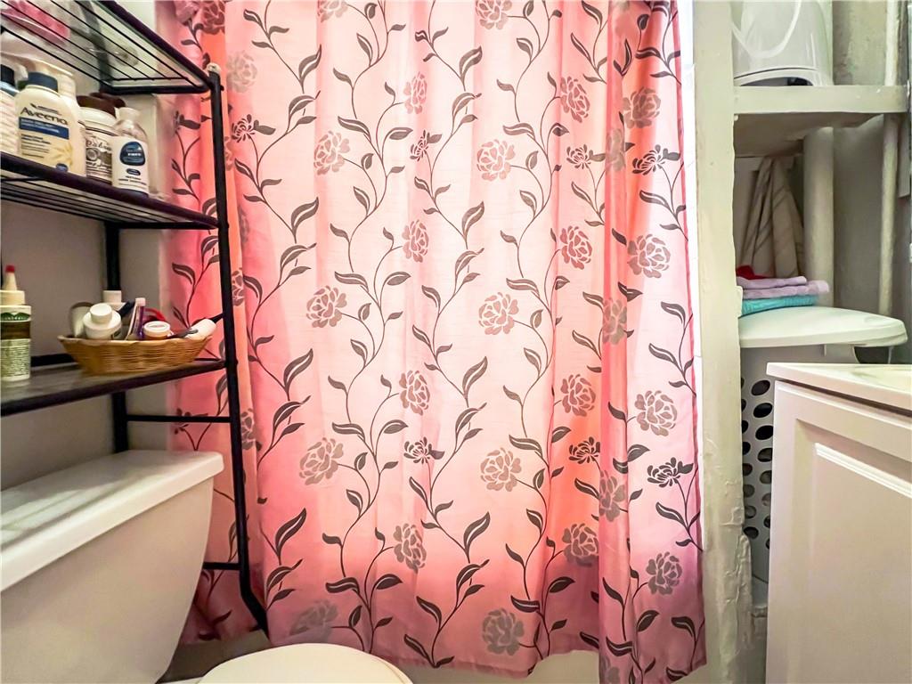 5907 4th Avenue Brooklyn, NY 11220 - Photo 34 of 37 a bathroom with a sink and a mirror