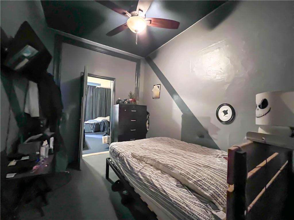 5907 4th Avenue Brooklyn, NY 11220 - Photo 8 of 37 a bedroom with a bed and a chandelier