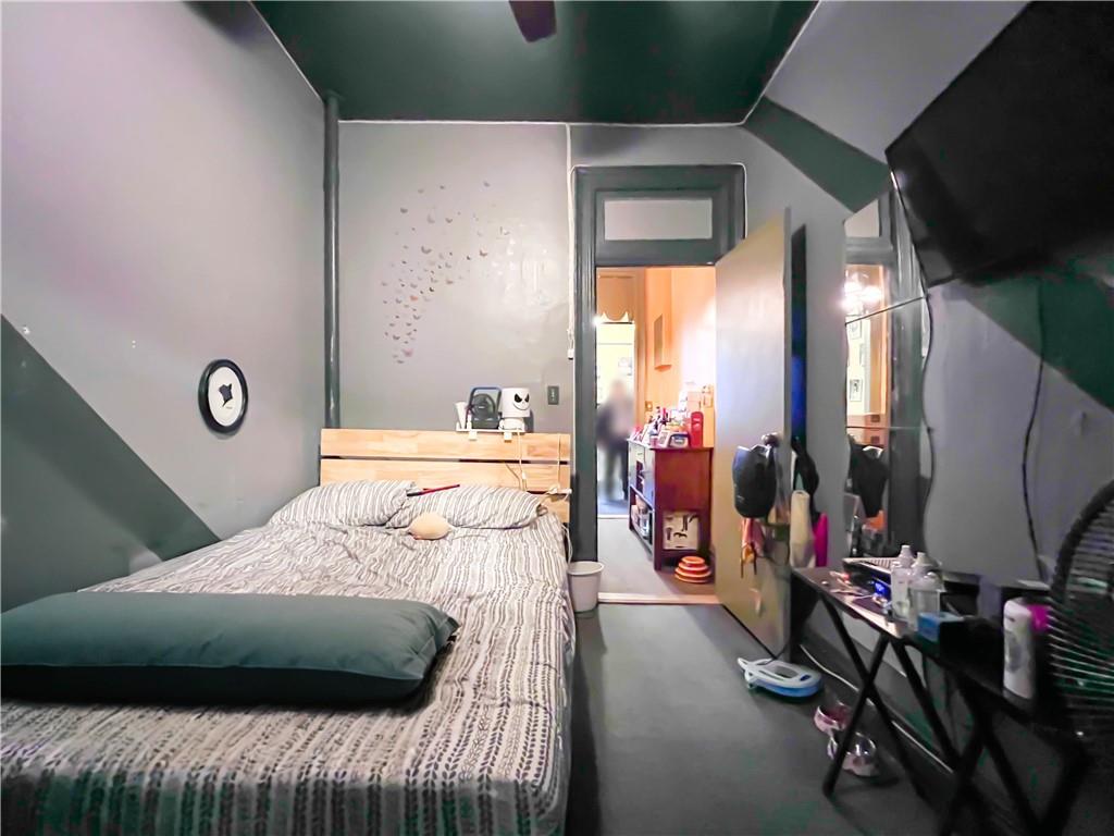 5907 4th Avenue Brooklyn, NY 11220 - Photo 9 of 37 a bedroom with bed and a large window