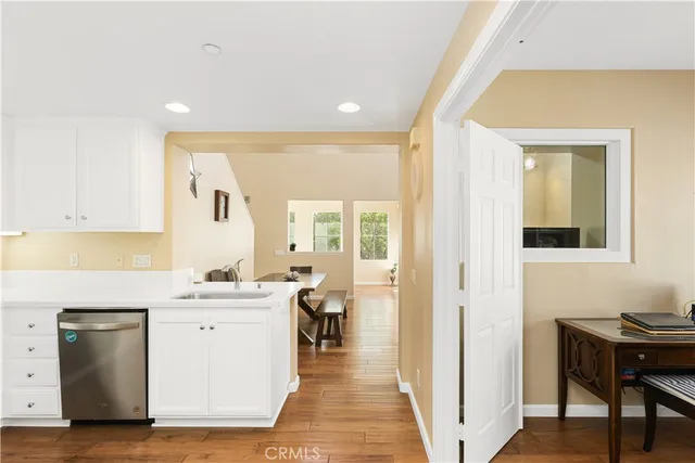 a view of a hallway with a kitchen