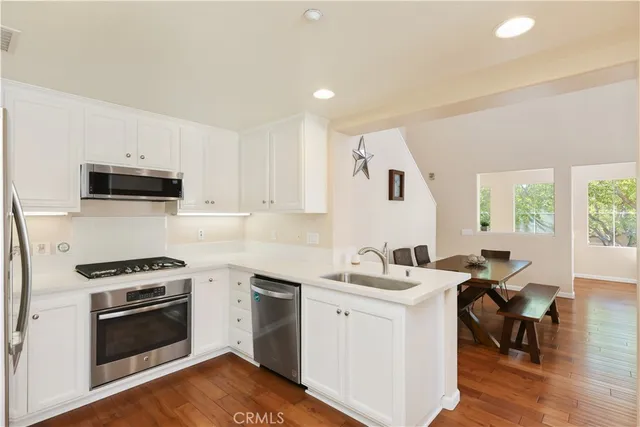 a kitchen with a sink stove top oven and cabinets