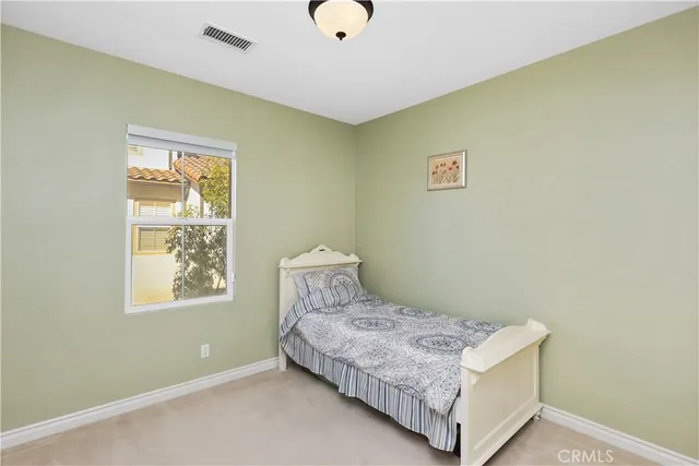 a bedroom with a bed and window