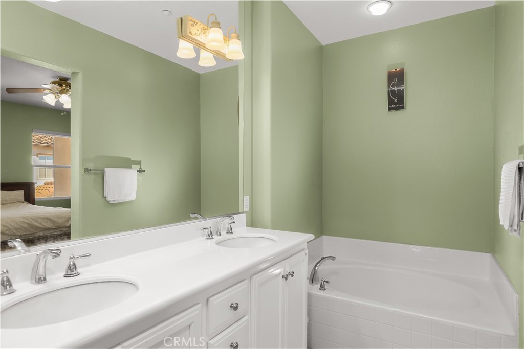 51 Olivehurst Irvine, CA 92602 - Photo 24 of 45 a bathroom with a tub sink and mirror