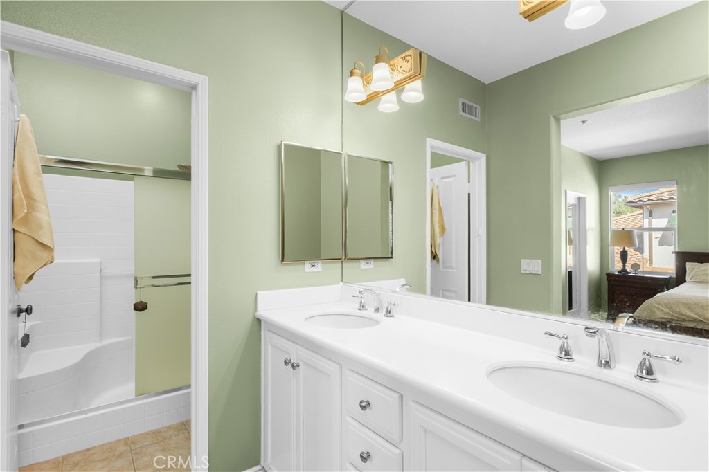 51 Olivehurst Irvine, CA 92602 - Photo 26 of 45 a bathroom with a double vanity sink mirror and bathtub