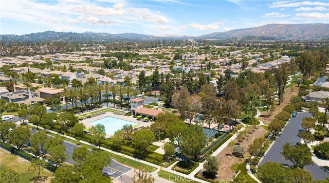 an aerial view of residential houses with city view