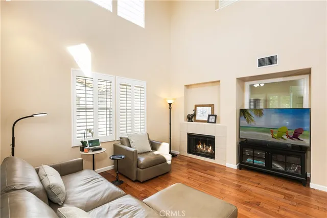 a living room with furniture flat screen tv and a fireplace