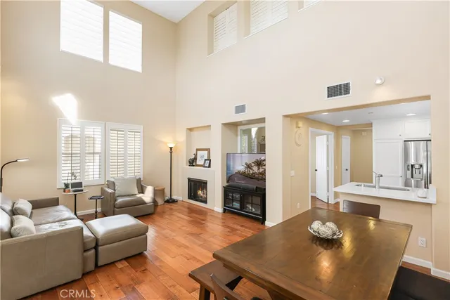 a living room with fireplace furniture and a table
