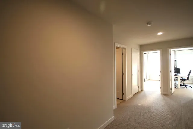 a view of a hallway with bathroom