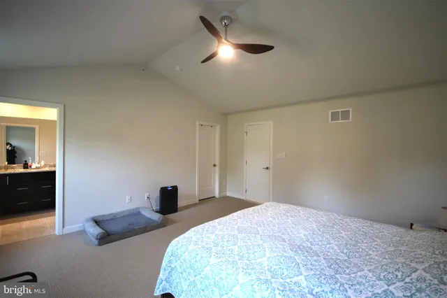 a bedroom with a bed and a lamp