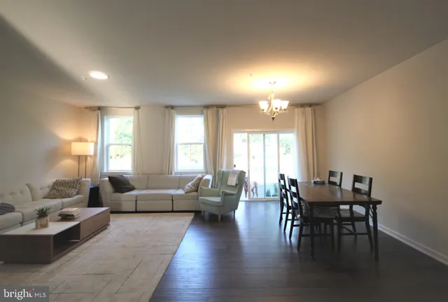 a view of a livingroom with furniture window and wooden floor